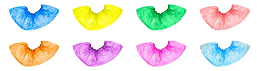 Isolated multicolored, disposable, medical Shoe covers on a white background. Shoe covers are blue, yellow, green, red, orange, pink, purple. The view from the top.