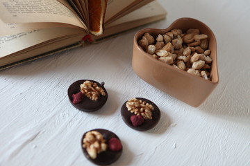 Mix nuts, dry fruits and chocolate on a white background