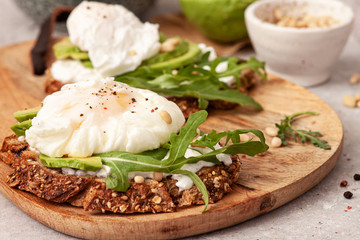 Sandwich with whole grain bread ,avocado and poached egg