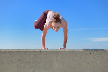 Portrait of a fit woman who practices yoga outdoors. Woman practicing asanas on a sunny day