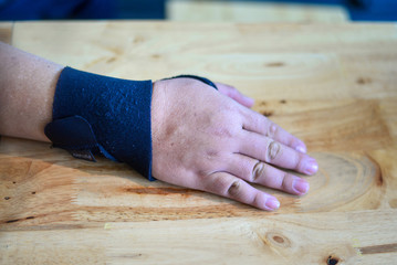 Injured patient broken wrist and arm with black bandage.