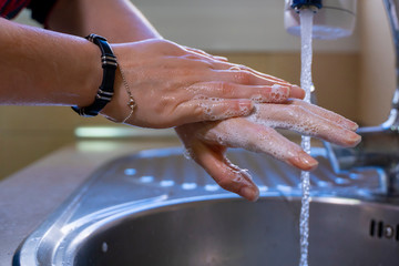 Washing hands properly. Hygiene concept. Rubbing back of hand with soap.