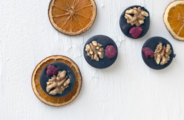 Mix nuts, dry fruits and chocolate rings on a white background