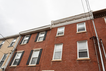 Fototapeta premium View up the face of mixed inner city housing in different styles, horizontal aspect