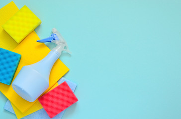 Cleaning set for different surfaces in kitchen, bathroom and other rooms. spray bottle with Shape Sponge and kitchen rags on a blue background. flat lay,  Cleaning service concept. Spring cleaning.