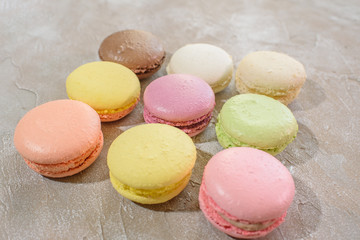Macarons on a concrete background. Isolates. Multi-colored. Beautiful background.