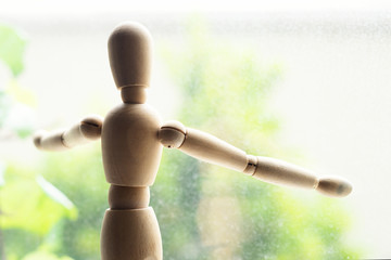 man silhouette looking to window from inside of room. self isolation quarantine concept.