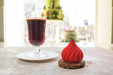 Dessert dome and mulled wine on the table in a cozy coffee shop. Delicious food and drinks. Close-up.