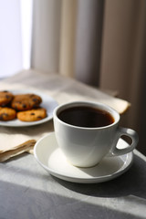 Delicious coffee, cookies and newspaper on table. Good morning
