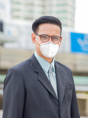 Asia young business man in front of the modern building in downtown .Concept of young  business people