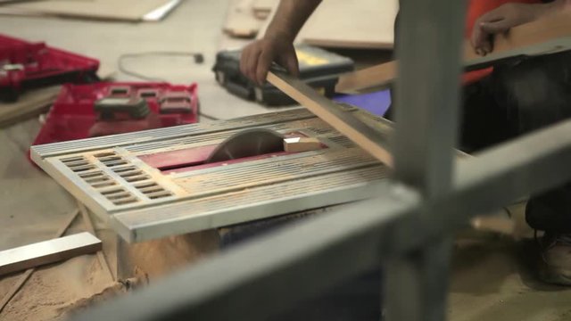 Worker cutting wooden with woden cuter. Close up shoting