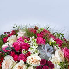 Flower arrangement with roses on light grey blue background