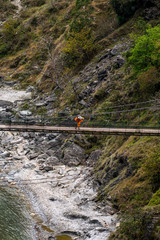 Naklejka premium A man walking in a River bridge