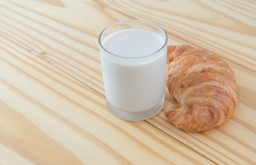 Croissant bakery with milk on the wooden table