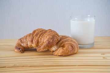 Croissant bakery with milk on the wooden table