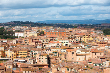 Fototapeta na wymiar aerial view over roofs of the Siena, medieval town, capital of the province of Siena in Tuscany, Italy