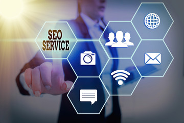 Writing note showing Seo Service. Business concept for techniques and procedures to increase the...