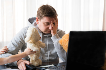 Young man in sports hoody at telework due to home quarantine of coronovirus pandemic...