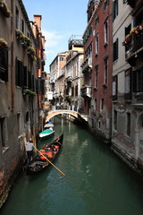 Obraz na płótnie Canvas Gondola floats on a narrow canal in Venice