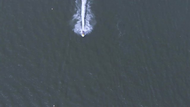high speed motorboat makes sudden turn at lake