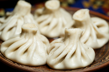 Georgian national dish Khinkali. Laid on a clay plate
