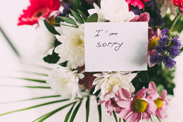 greeting card with the words I'm sorry in a beautiful bright bouquet of flowers 