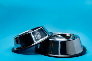 Pet shop concept.  Stainless bowl on blue background