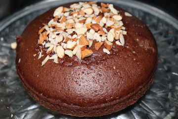 yummy and tasty home made chocolate cake garnished with dry fruits, stay home and make tasty recepies at home.
