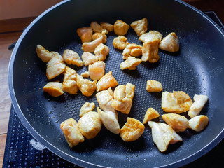 Pieces of chicken meat in a pan. Spiced meat prepared for consumption.