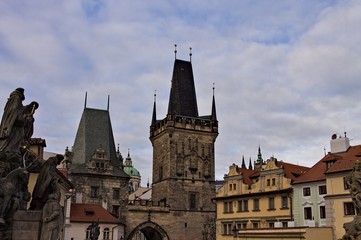 Fototapeta na wymiar The Lesser Town Bridge Tower and the statues on the Charles Bridge (Prague, Czech Republic, Europe)