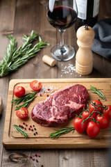 ribeye steak on a wooden board. raw meat, beef. View from above
