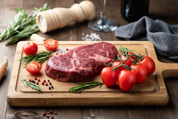 ribeye steak on a wooden board. raw meat, beef. View from above