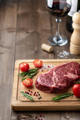 ribeye steak on a wooden board. raw meat, beef. View from above