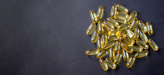 Yellow pills on a dark background