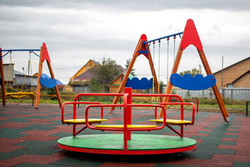 Multi-colored children's carousel in the playground © vitec40