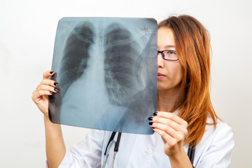 Doctor examines a lung x-ray - Powered by Adobe