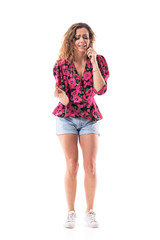 Frustrated young woman arguing on the mobile phone explaining and yelling expressively. Full body isolated on white background. 