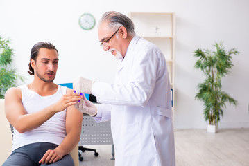 Fototapeta premium Young male patient visiting experienced doctor