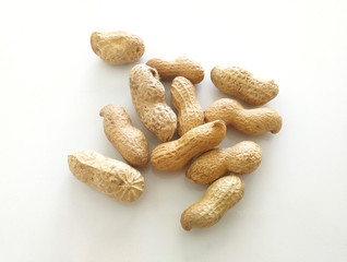 Peanuts in shells on white background Organic dried fruits for a healthy diet and ideal for peanut butter. Aerial view.