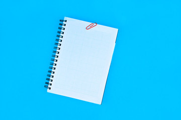 Pink colored paper clips holding some paper of a white colored paper diary