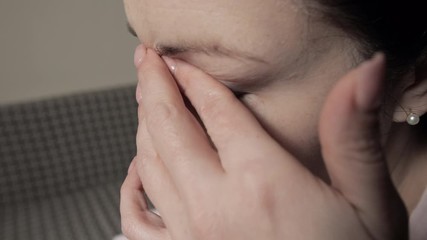 Face touch - coronavirus concept. Woman touching eye, increase risk to viral infection. How can phone transmit COVID-19, transfer coronavirus from smartphone to face. Mobile phone hygiene