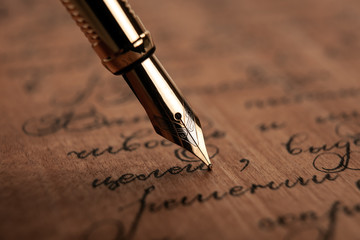 fountain pen on paper with ink text on the wooden desk