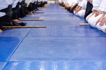 People in kimono on martial arts weapon training seminar