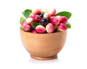 Carissa ( carandas Linn, Carunda,  Karonda, Bengal currants, Karanda plum or Koromcha ) fruit in wooden bowl isolated on white background.