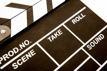 black movie clapper with white inscriptions closeup