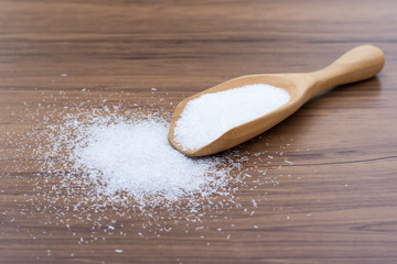 Monosodium glutamate ( MSG ) isolated on wood table background. 