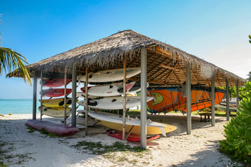 Straw shed with surfboards on the beach