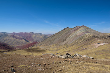 Lush green and red valleys around the Palccoyo Rainbow Mountains, Peru
