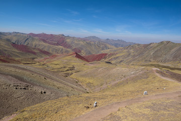 Lush green and red valleys around the Palccoyo Rainbow Mountains, Peru