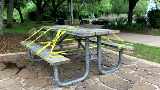A public park picnic table taped off after lock down mandate issued due to the coronavirus COVID19 pandemic.